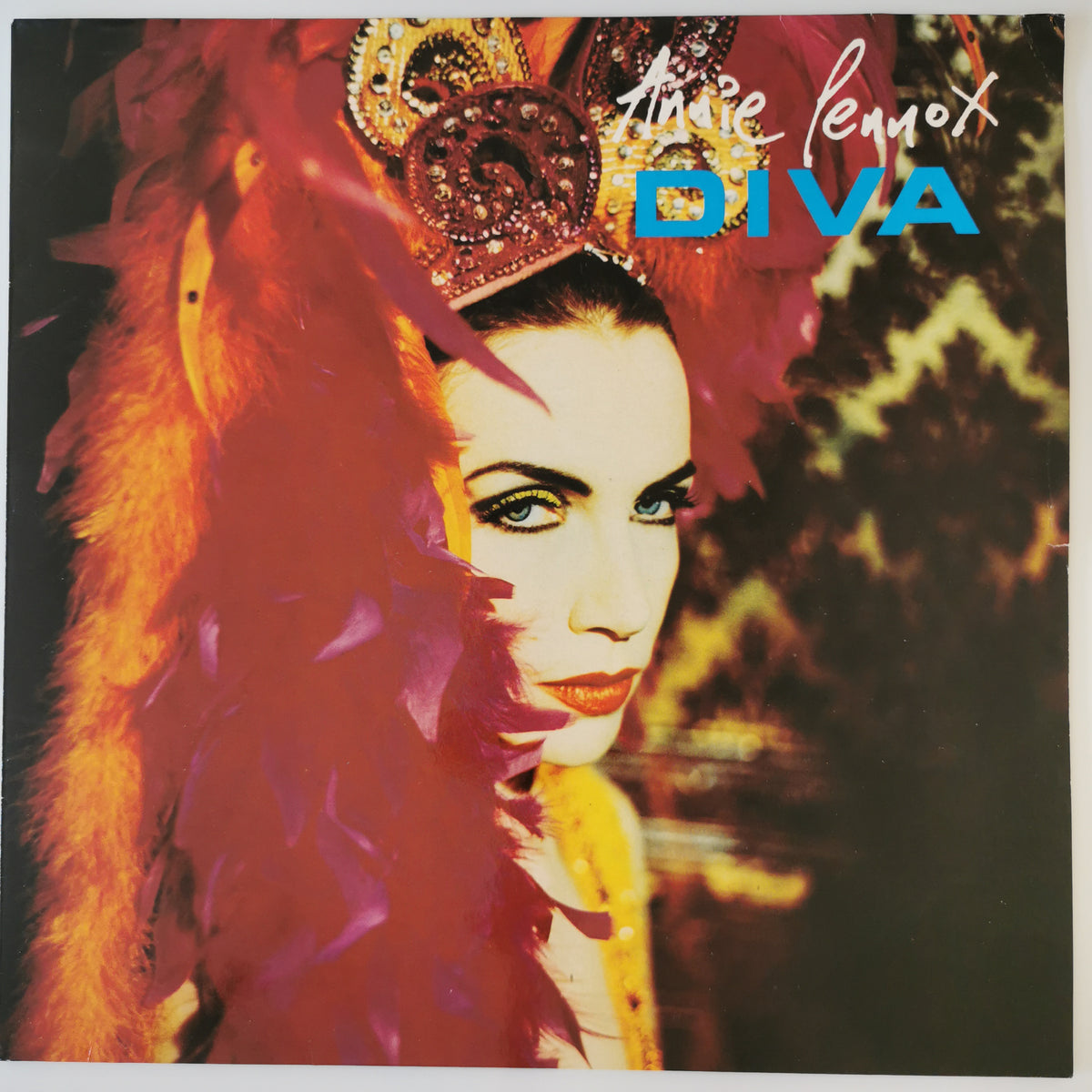 Vinyl album cover for Tine Le Moox's 'DIVA', featuring a stylized portrait of a woman with a large feathered headdress in red, orange, and purple tones against a dark background with yellow graphic elements.