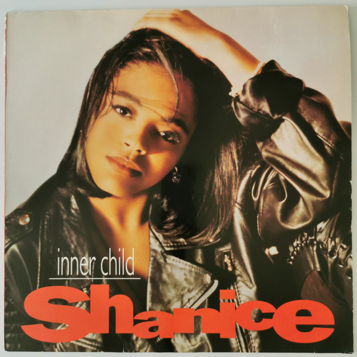 Shanice 'inner child' vinyl record cover, featuring a portrait of the artist in a black leather jacket against a light background with bold red text.