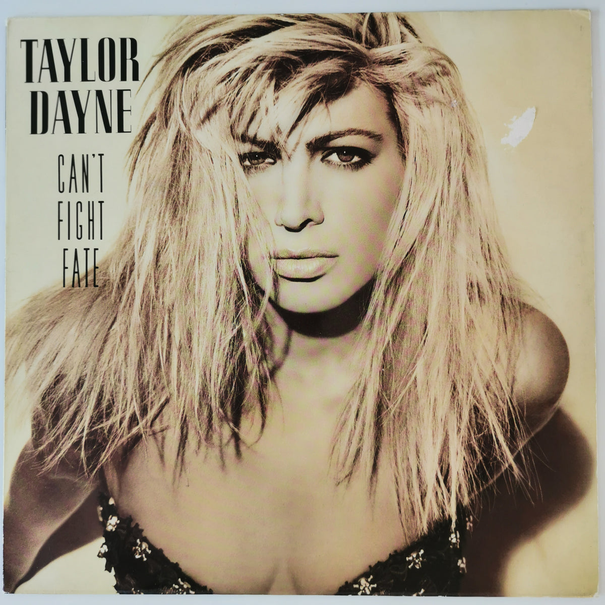 Taylor Dayne 'Can't Fight Fate' vinyl record cover, featuring a sepia-toned close-up portrait of the artist with long blonde hair and black text on the left side.