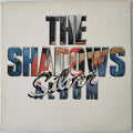 The Shadows 'Silver' album cover, featuring the band name 'THE SHADOWS' in large 3D letters with guitar imagery inside, and 'Silver' in cursive script across the front, set against a cream-colored background.