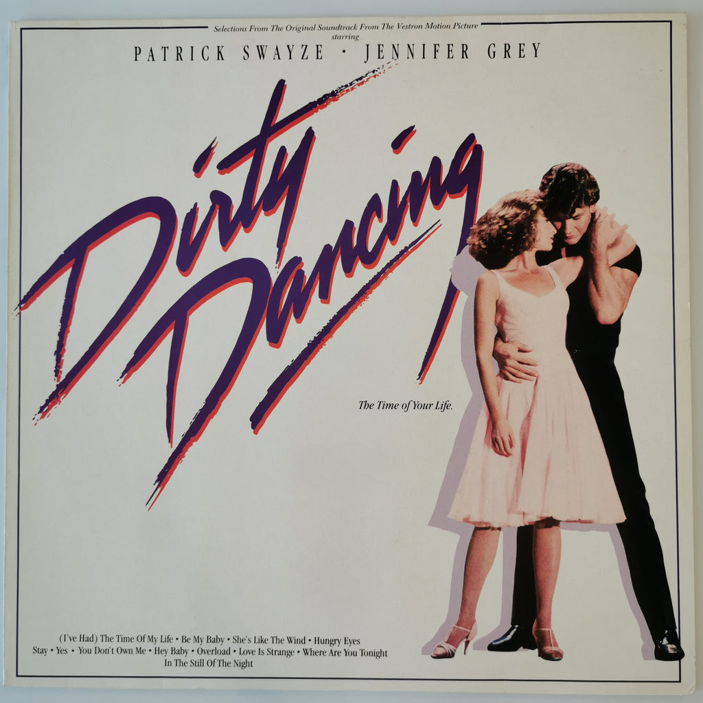 Vinyl record cover for the soundtrack to the film Dirty Dancing, featuring Patrick Swayze and Jennifer Grey in a romantic pose on the right, with the title 'Dirty Dancing' in large stylized purple and red brushstroke lettering on the left, all on an off-white background.