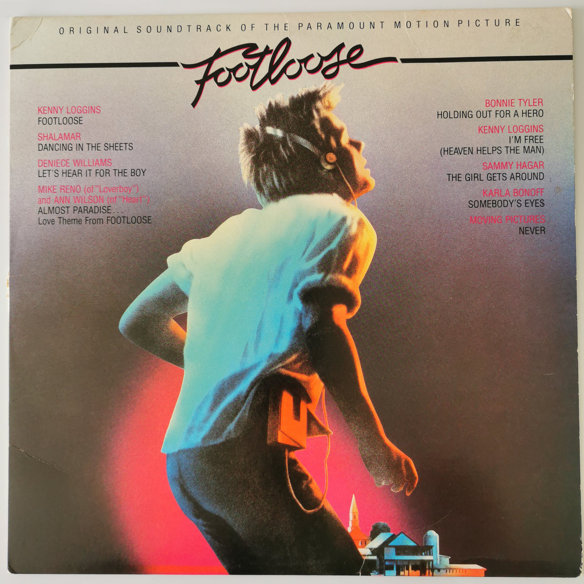 The front cover of the 'Footloose' original soundtrack album by the band kenny loggins, featuring a stylized graphic of a person in a white shirt against a dark background with pink and orange lighting, and tracklist text on both sides.