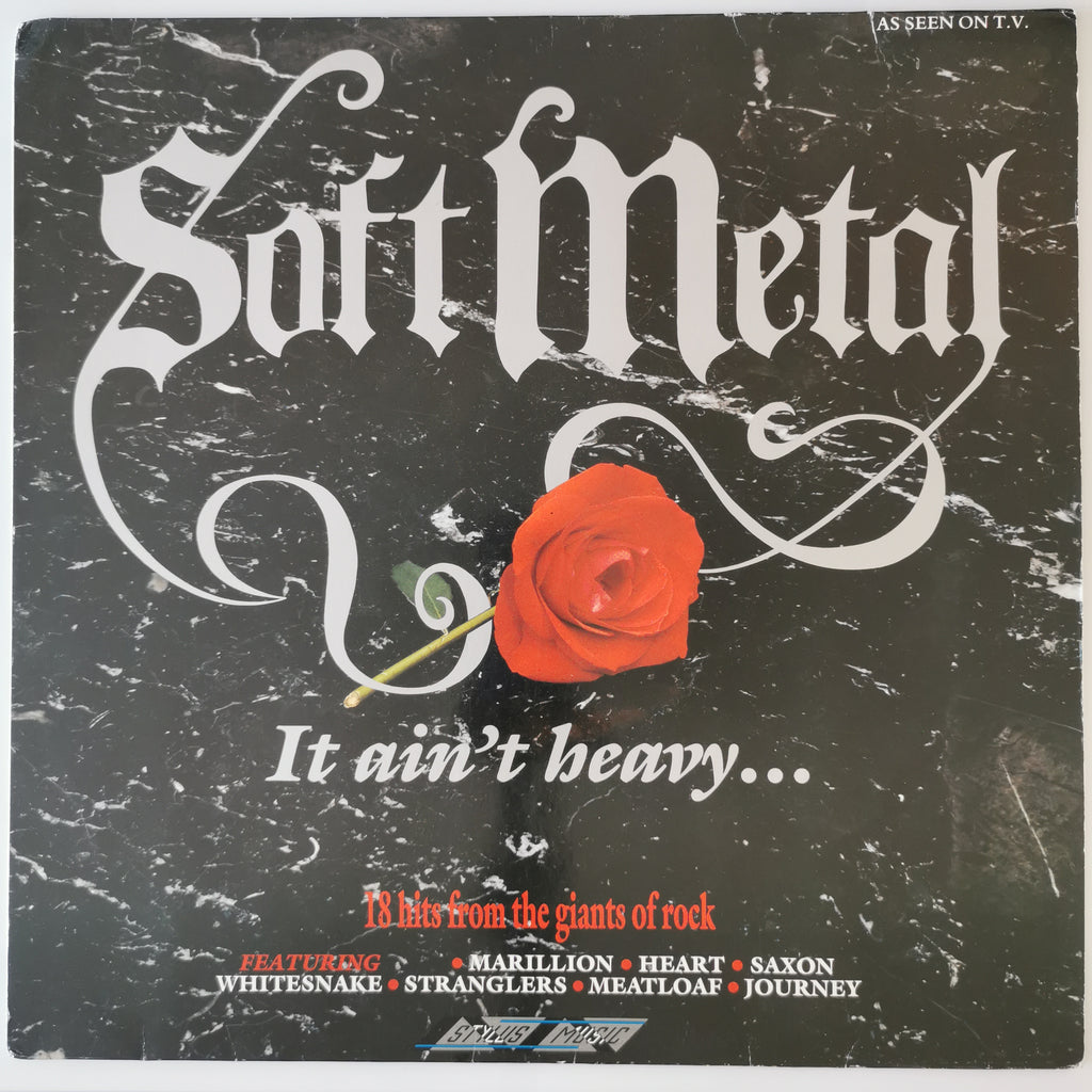 A square album cover for 'Soft Metal' with a distressed black marble background, large white gothic title text, a red rose in the center, and smaller red and white track/promoter text at the bottom.