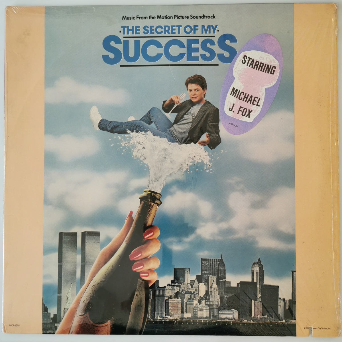 The Secret of My Success motion picture soundtrack vinyl record cover, featuring a illustrated scene of Michael J. Fox floating above a city skyline while a hand holds a champagne bottle.